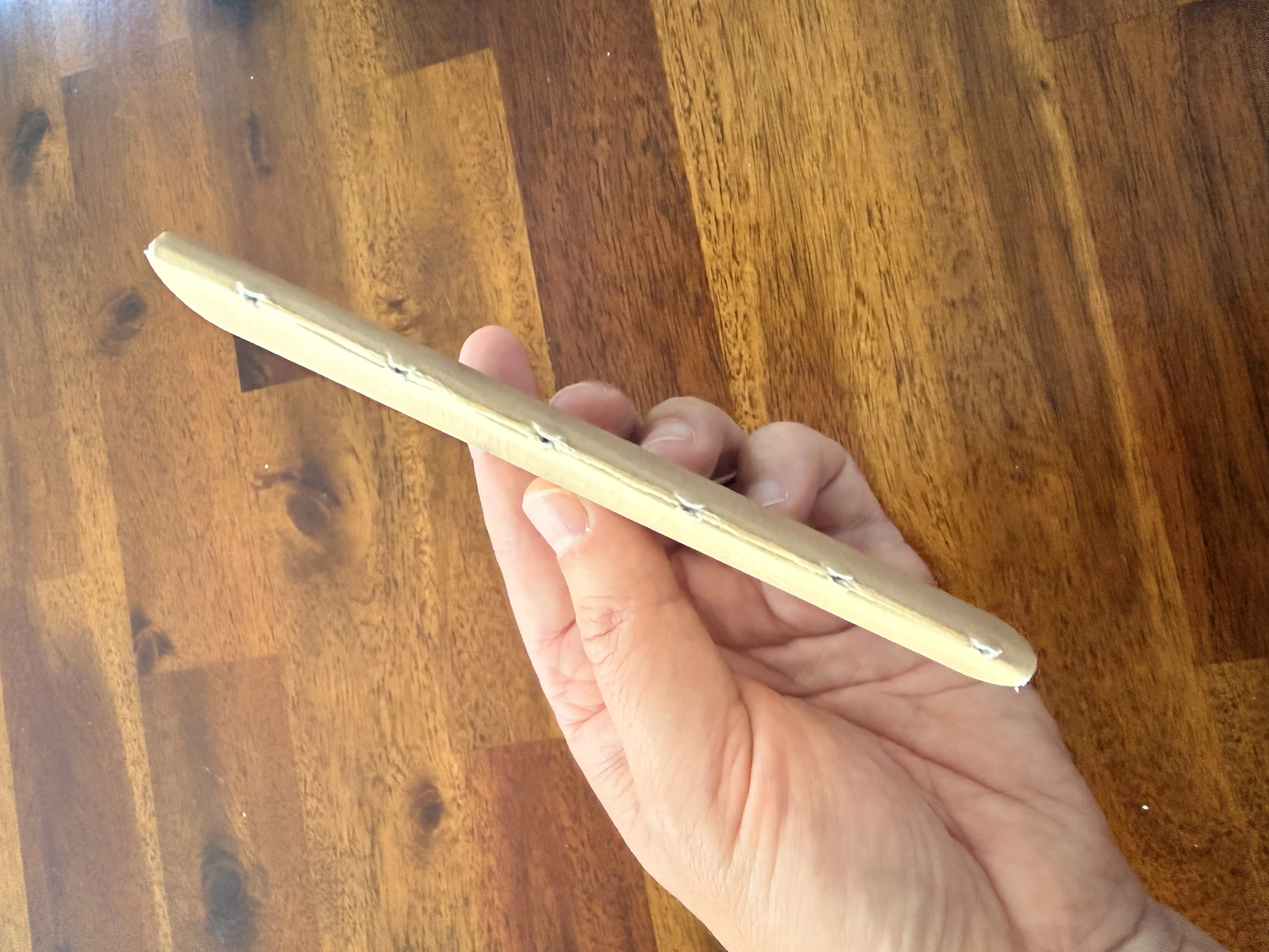 Close view of the six hand stitches along the notebook spine