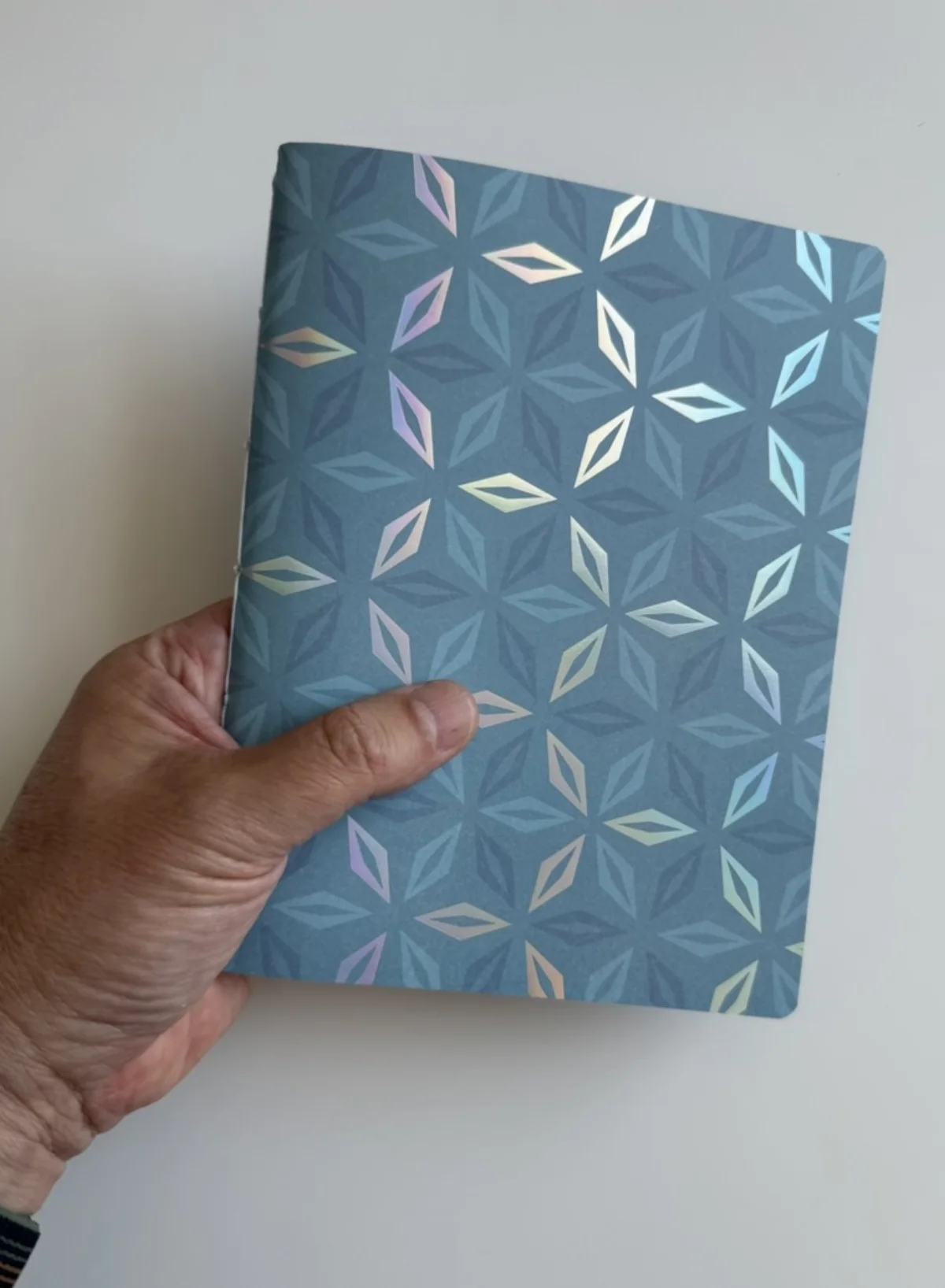 Patterned standard-size notebook held in one hand