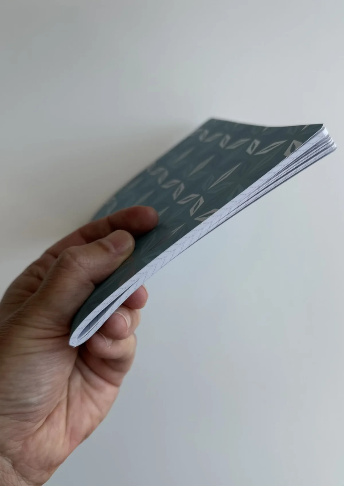Side view showing the stitched notebook and sixty-page block