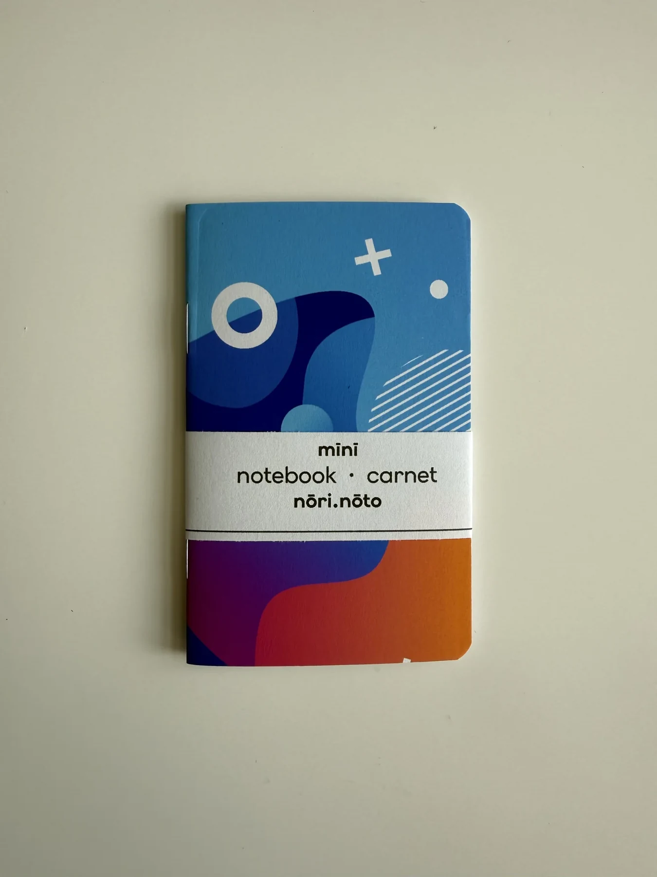 Blue Mīnī Fankī notebook with flowing abstract shapes
