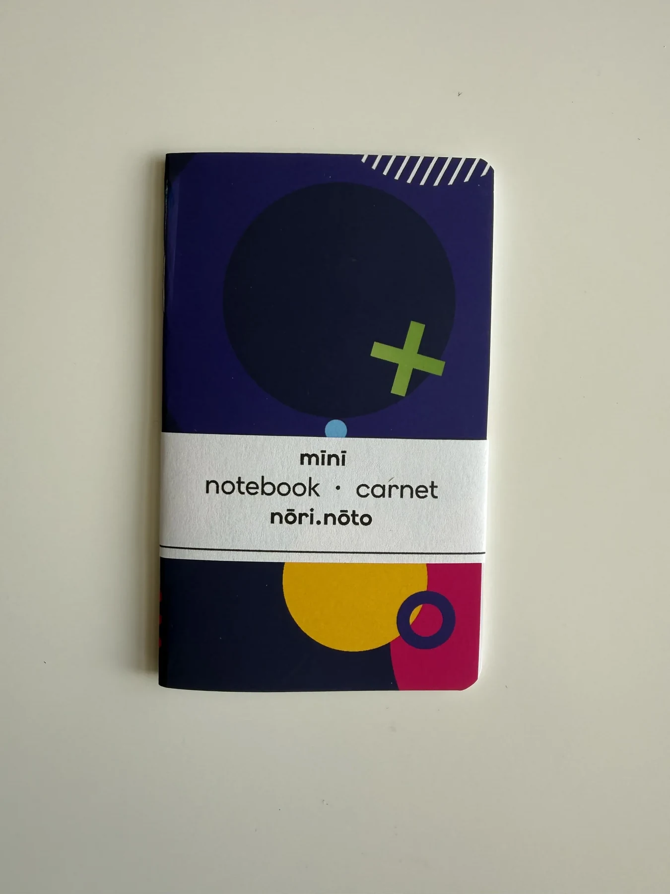 Purple Mīnī Fankī notebook with circles and a lime cross
