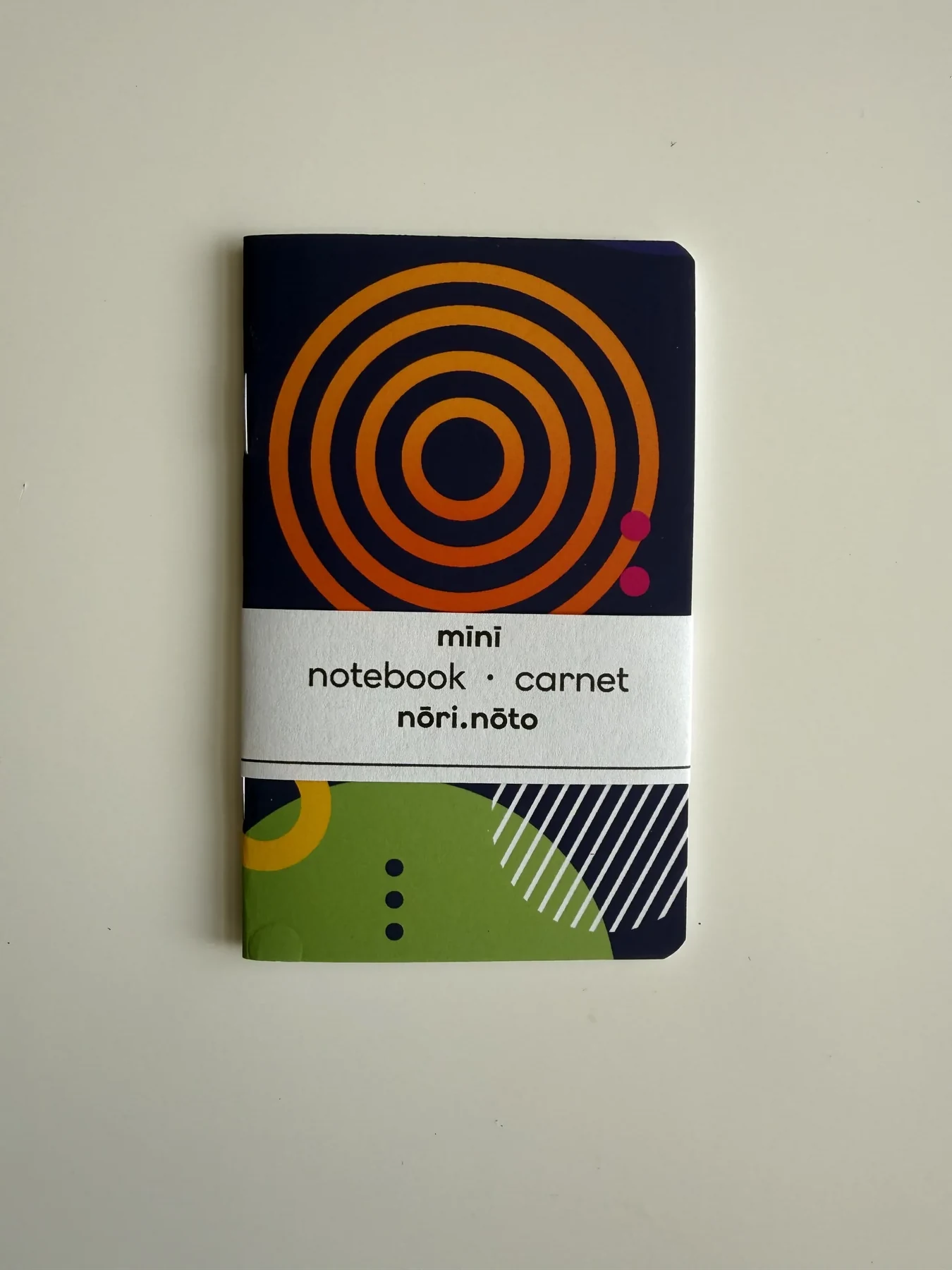 Navy Mīnī Fankī notebook with concentric orange rings