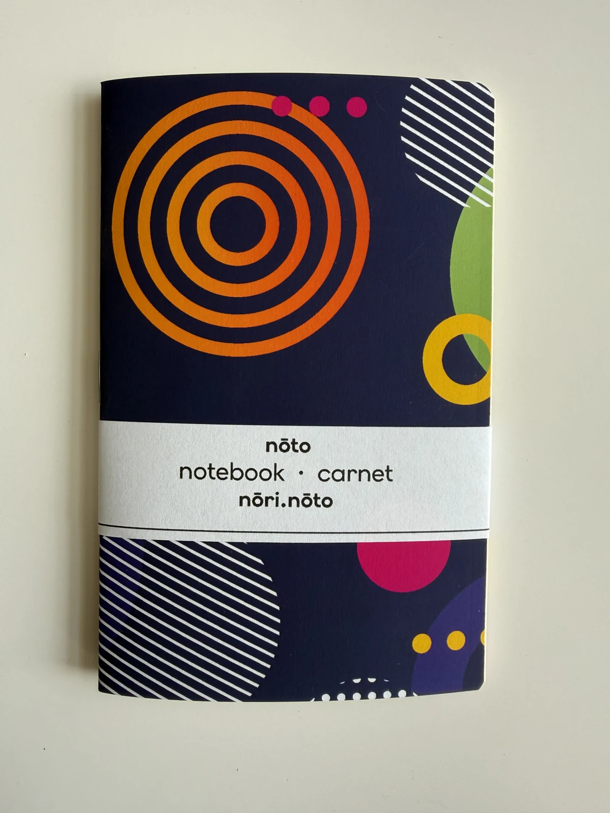 Nōto Fankī notebook with orange rings and graphic shapes