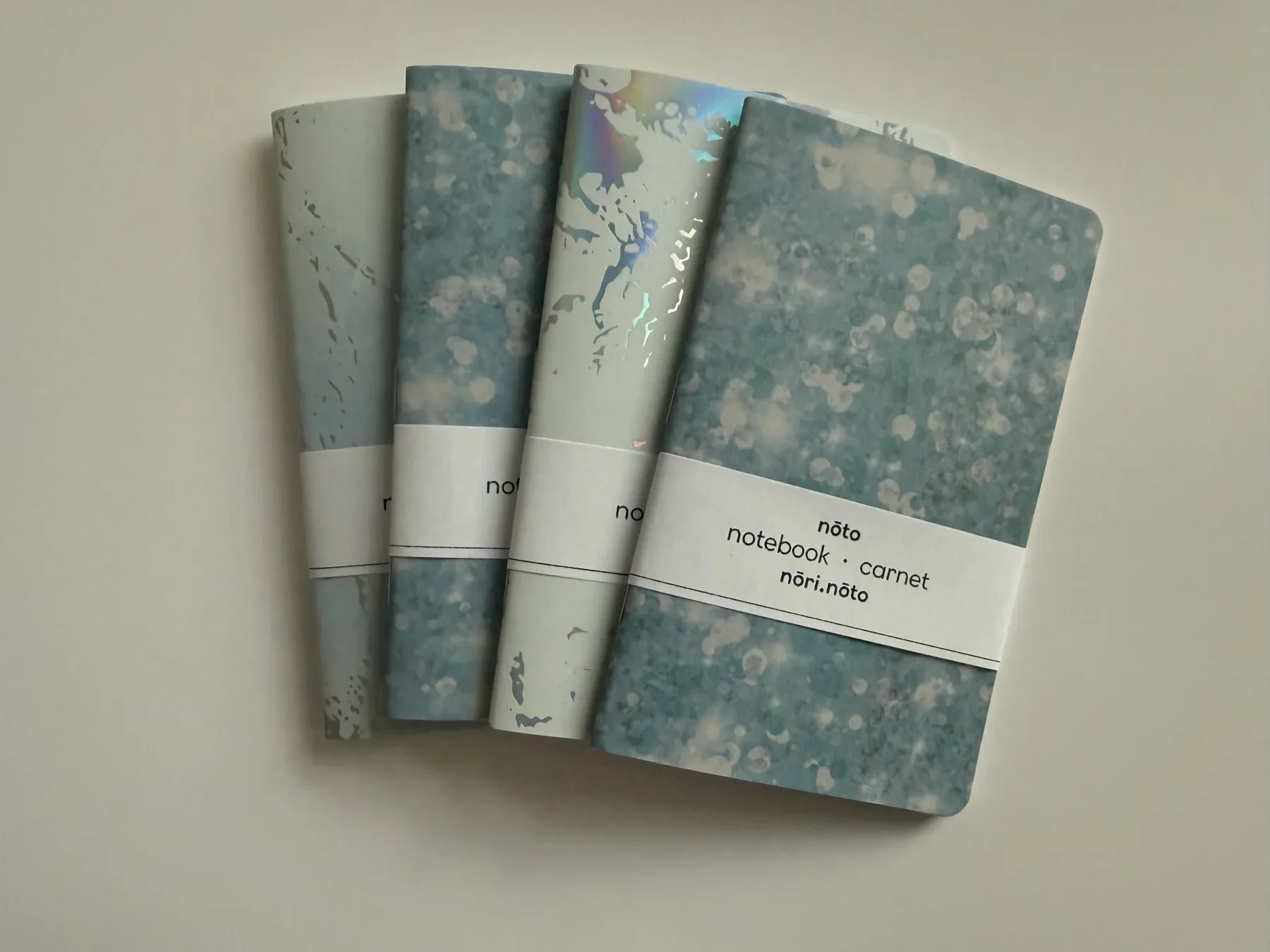 Four Nōto notebooks with varied creative-paper covers