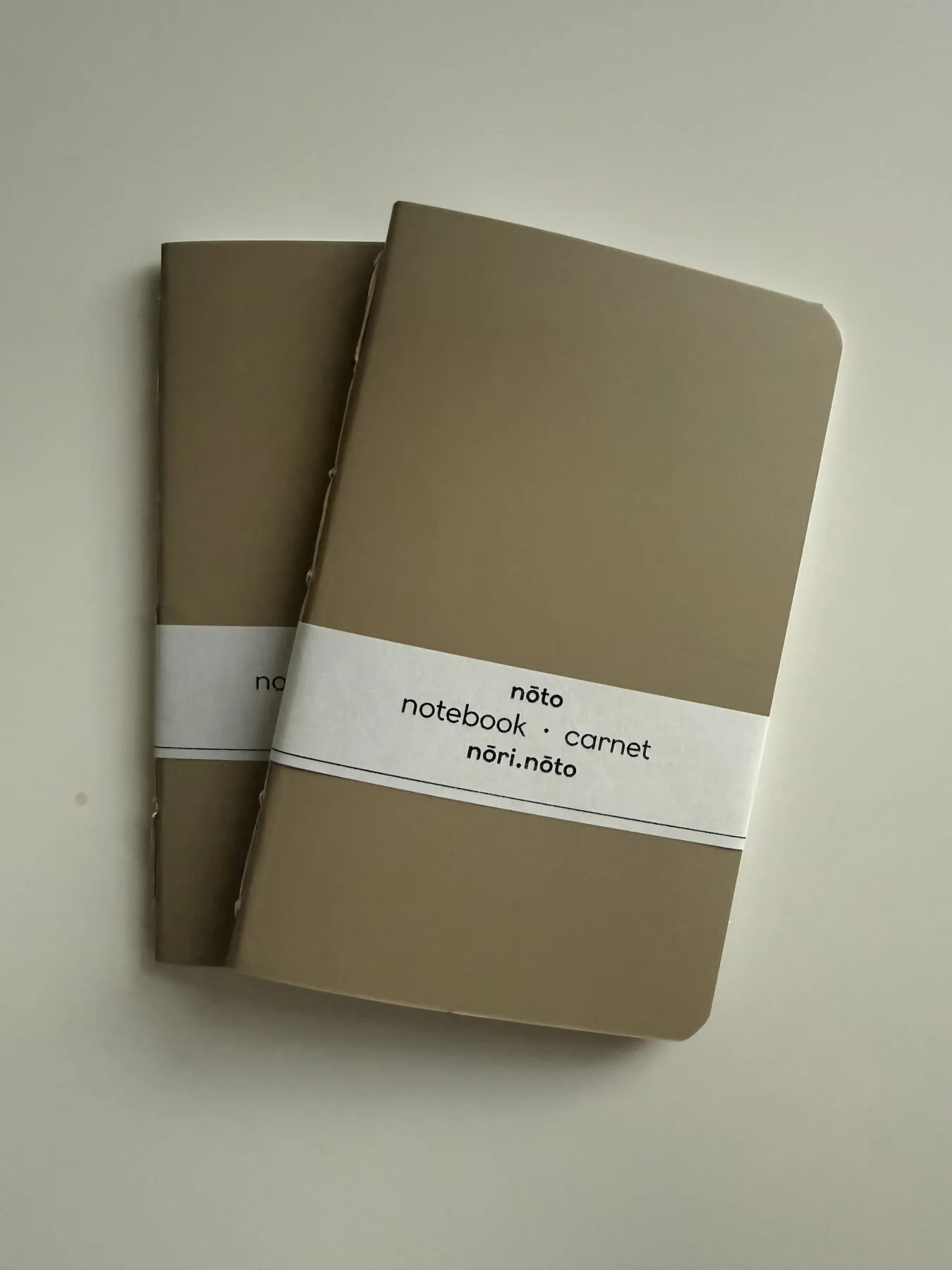 Two brown-paper Nōto notebooks with hand-stitched spines
